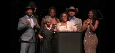 Adam and Elliott accepting an award at a formal ceremony