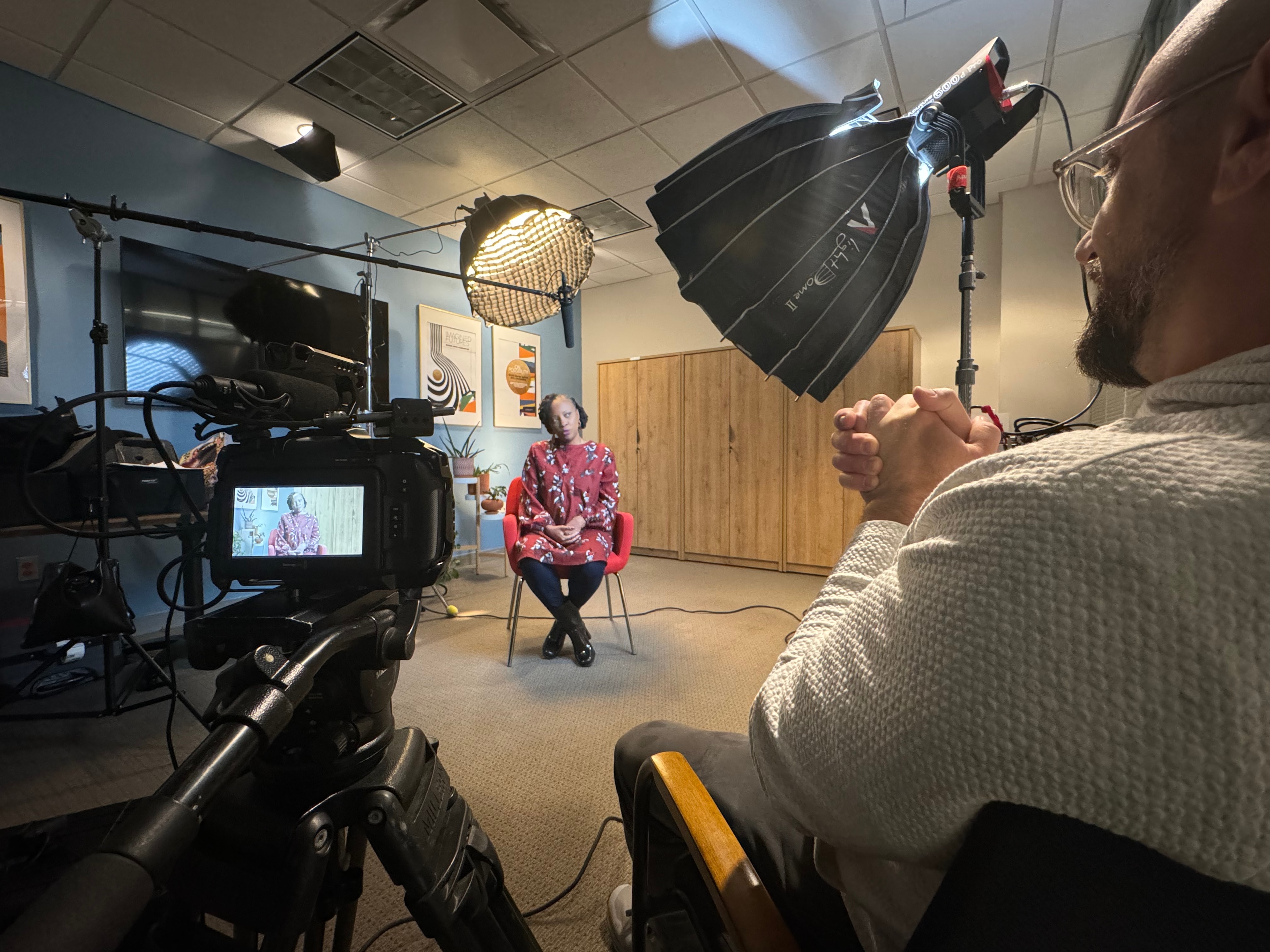 Filmmaker interviewing subject on a lit studio set