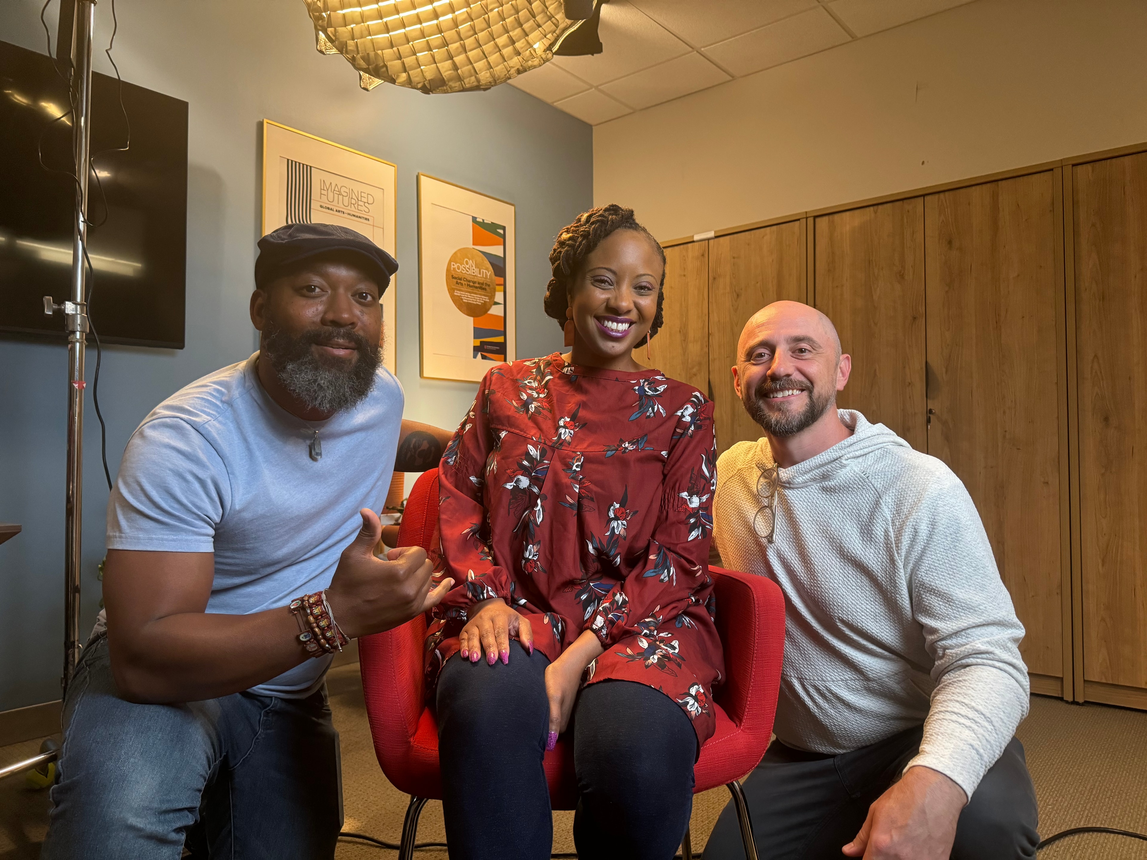 Adam, Elliott, and interview subject smiling together on set