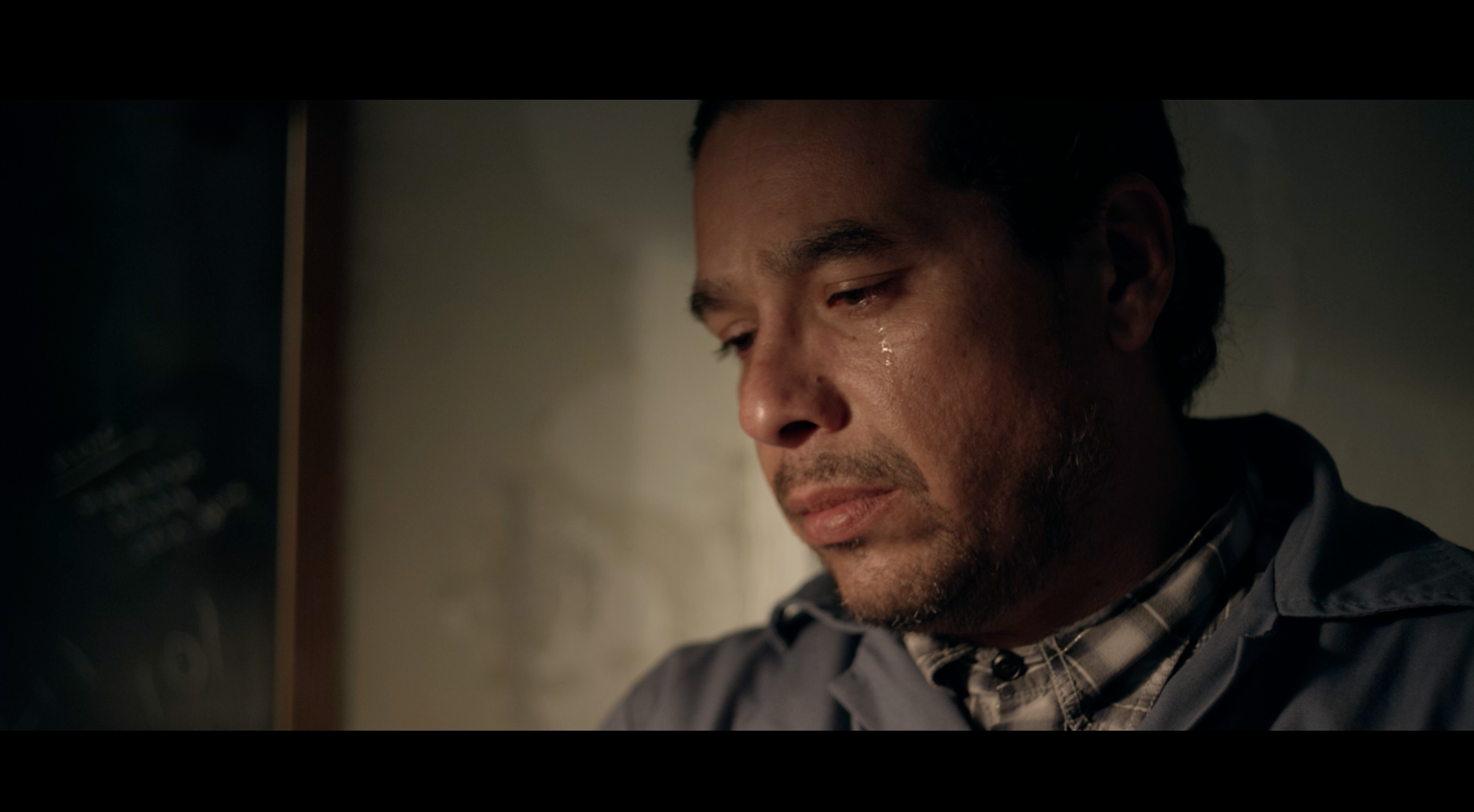 Man with tear on cheek in emotional close-up
