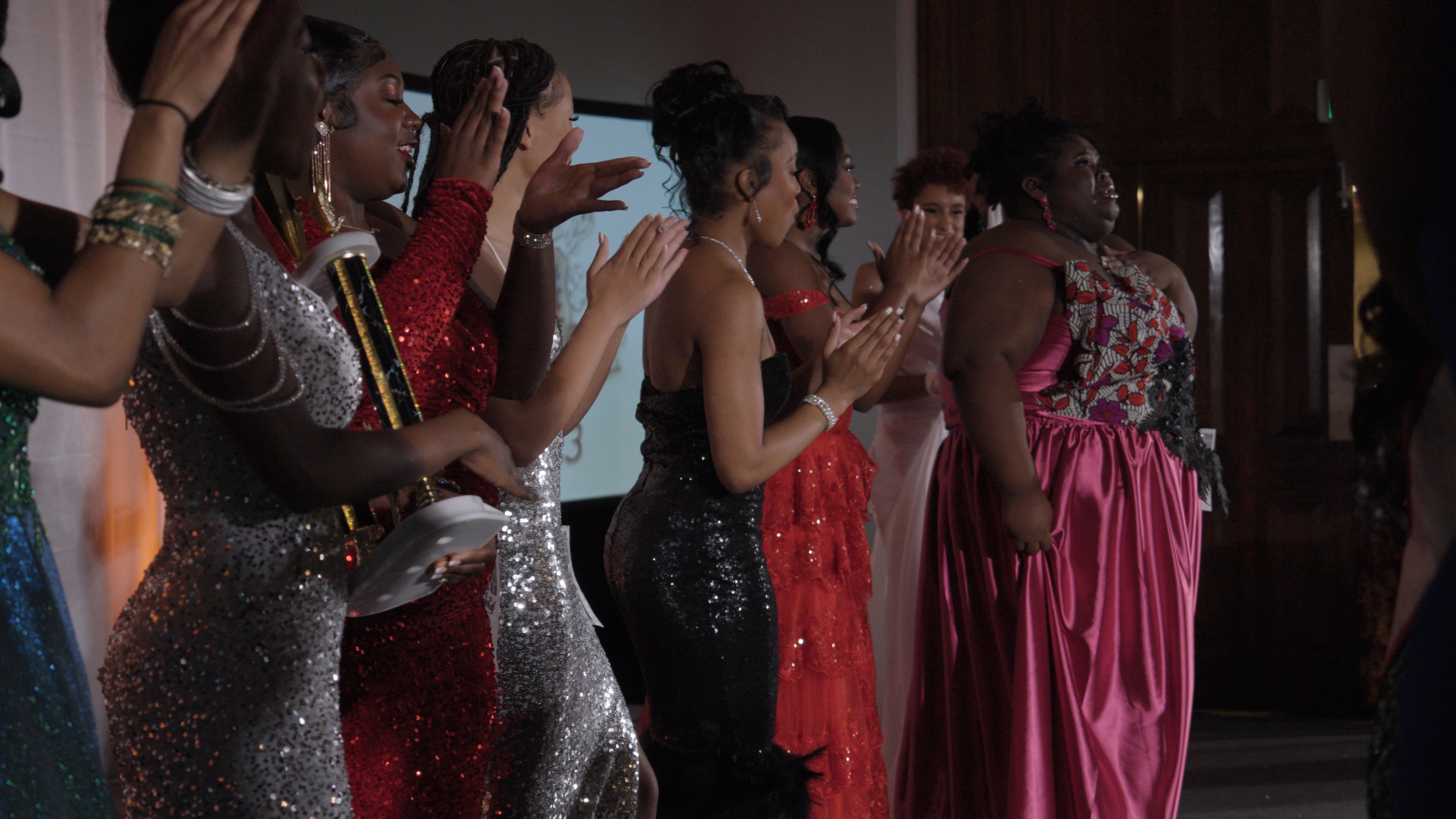 Women in sequin dresses celebrating together